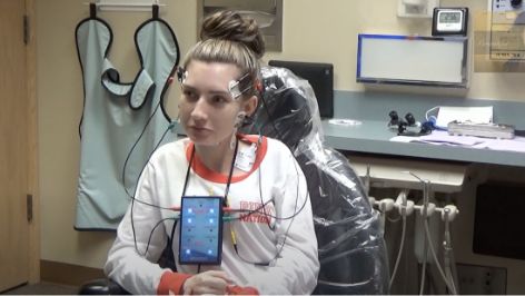 Young woman with several electrodes attached to her head