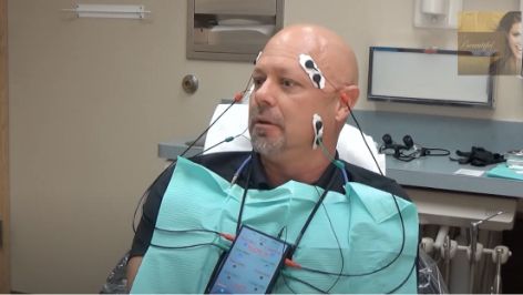 Man with several electrodes attached to his head and face